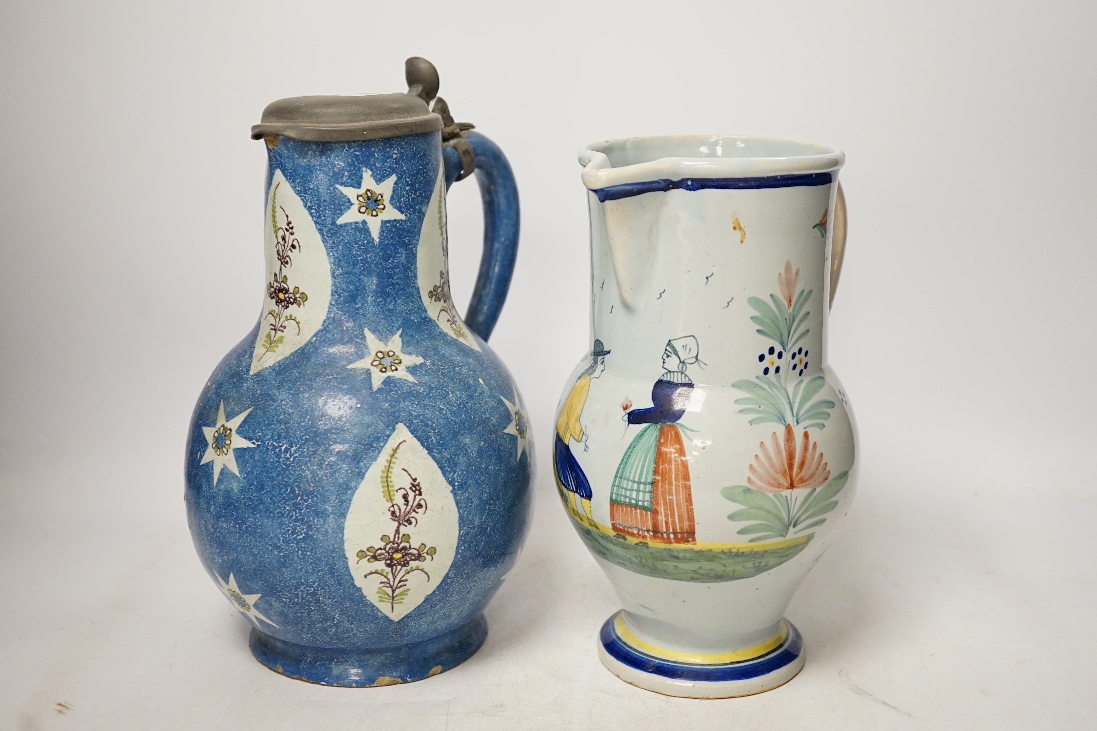 An 18th / 19th century Brussels faience jug and a French Quimper faience pottery jug, largest 25cm high. Condition - fair to good